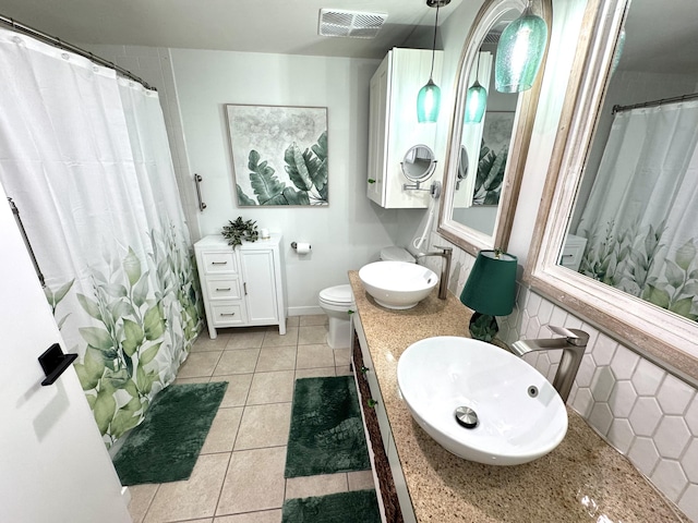 full bath with visible vents, a shower with shower curtain, toilet, tile patterned floors, and vanity