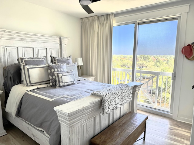 bedroom featuring access to exterior, ceiling fan, and wood finished floors