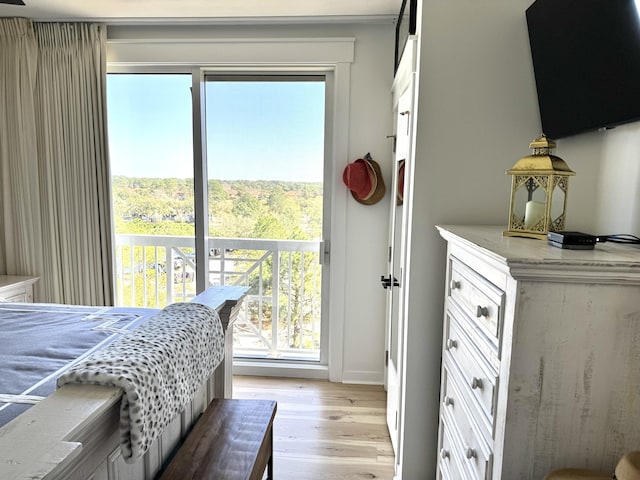 bedroom featuring light wood-type flooring and access to outside