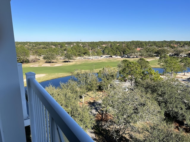 balcony featuring view of golf course and a water view