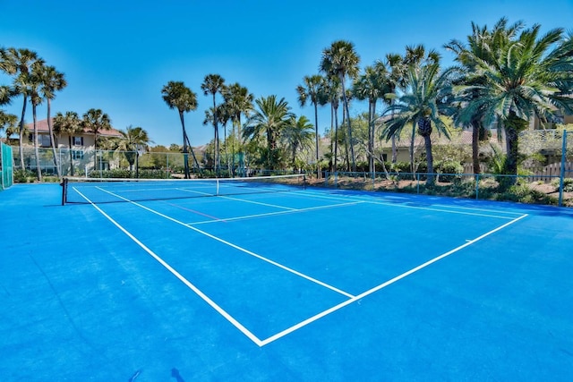 view of sport court featuring fence