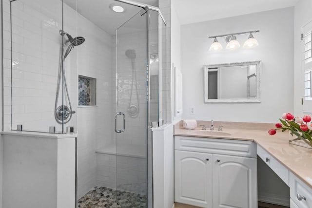 bathroom with a stall shower and vanity