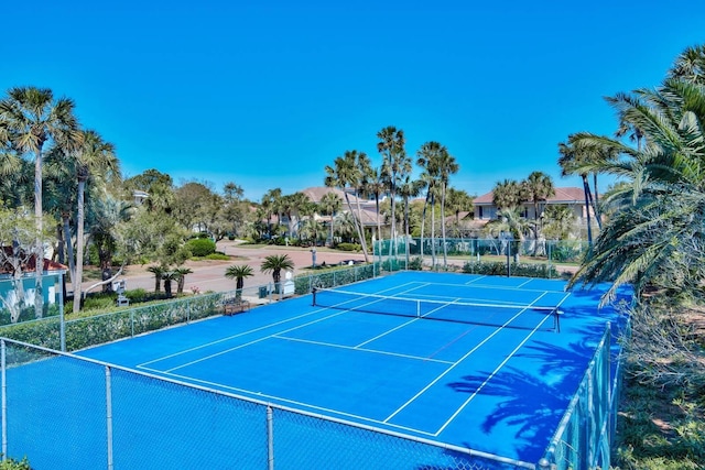 view of sport court featuring fence