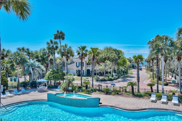 pool with fence and a patio