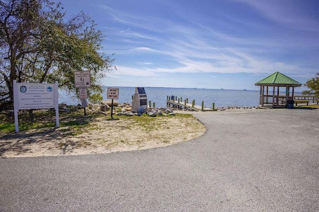 property view of water featuring a boat dock and a gazebo