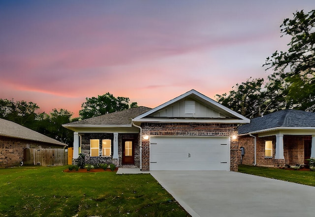 view of front of home with a lawn, concrete driveway, an attached garage, board and batten siding, and brick siding