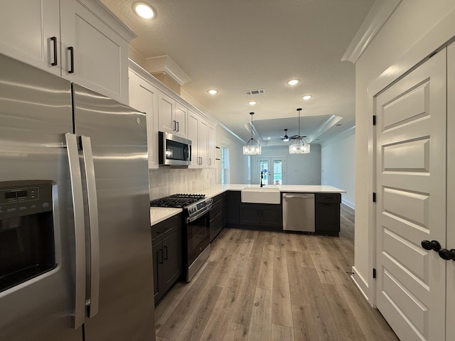 1575 Pine St, Niceville, FL 32578 - kitchen featuring stainless steel appliances, a sink, a peninsula, ornamental molding, and light countertops
