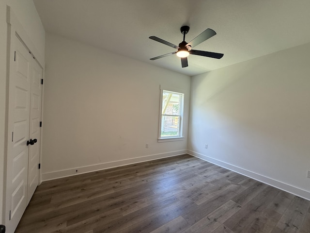 1575 Pine St, Niceville, FL 32578 - unfurnished room featuring dark wood-style floors, a ceiling fan, and baseboards
