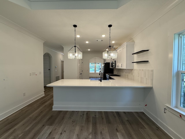 1575 Pine St, Niceville, FL 32578 - kitchen featuring arched walkways, ornamental molding, white cabinetry, stainless steel appliances, and baseboards
