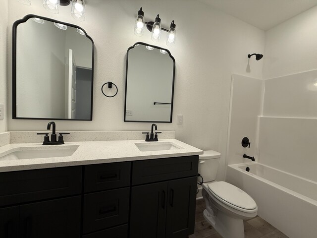 1575 Pine St, Niceville, FL 32578 - full bath featuring toilet, double vanity, shower / tub combination, and wood finished floors