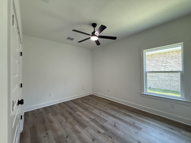 1575 Pine St, Niceville, FL 32578 - empty room with ceiling fan, dark wood-style flooring, baseboards, and a textured ceiling