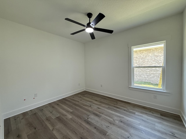 1575 Pine St, Niceville, FL 32578 - spare room featuring dark wood-type flooring and baseboards