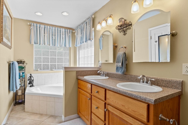 full bathroom with tile patterned flooring, a garden tub, a sink, and double vanity