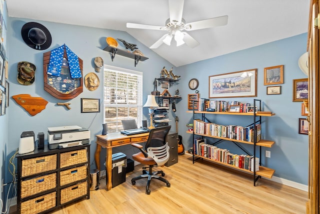 office space with baseboards, a ceiling fan, vaulted ceiling, and wood finished floors