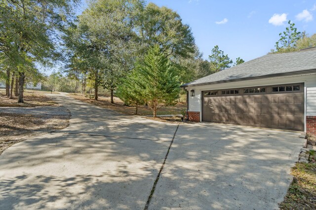 exterior space featuring brick siding and roof with shingles