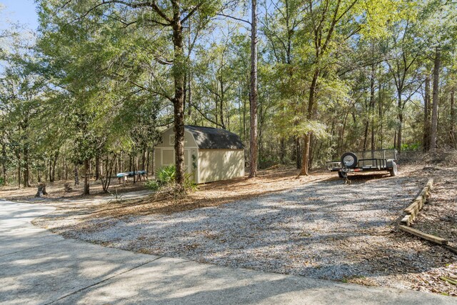 view of property's community with an outdoor structure and a storage unit