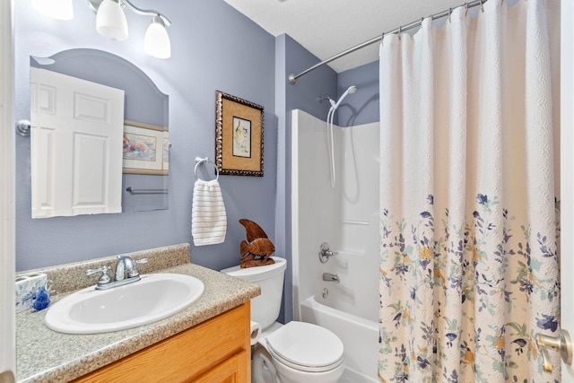 bathroom with vanity, toilet, and shower / bath combo with shower curtain