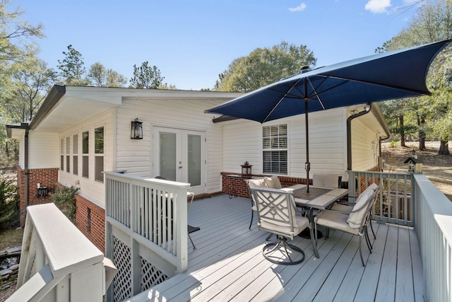 wooden deck featuring french doors and outdoor dining area