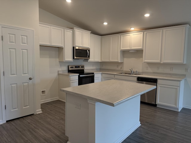 kitchen featuring a center island, dark wood-style floors, white cabinets, and stainless steel appliances