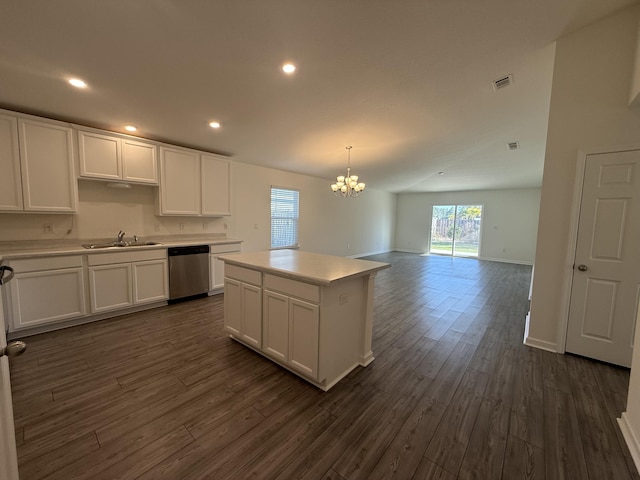 kitchen with stainless steel dishwasher, dark wood-style floors, visible vents, and white cabinetry