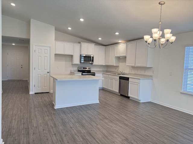 kitchen featuring dark wood-style floors, appliances with stainless steel finishes, white cabinets, and light countertops