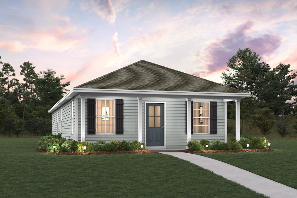view of front of property with a lawn and roof with shingles