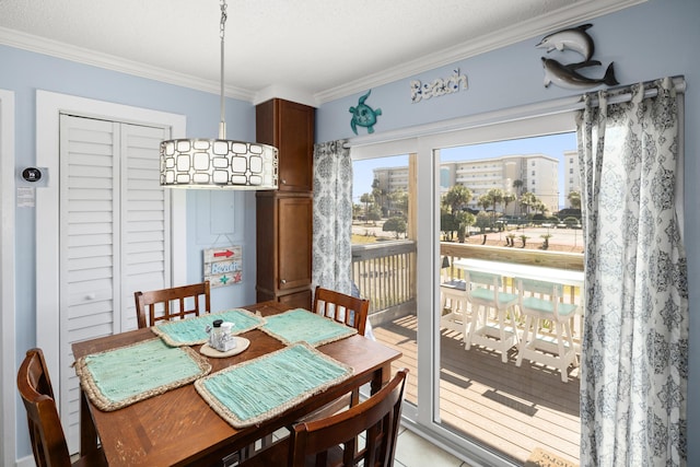 dining space with a city view and crown molding