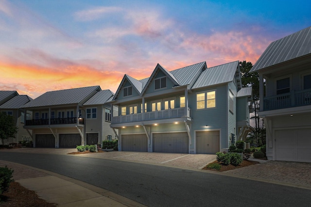 view of front facade featuring metal roof, driveway, and an attached garage