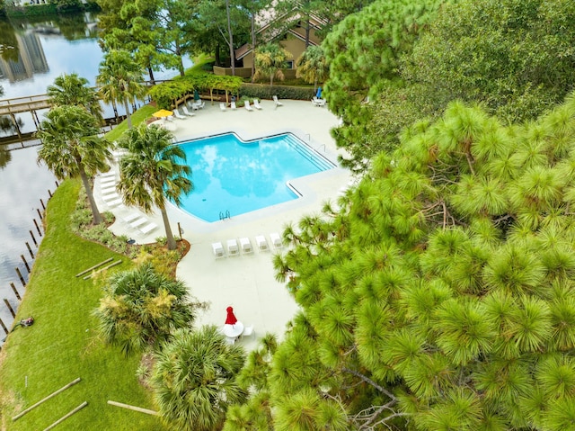 pool featuring a water view and a patio