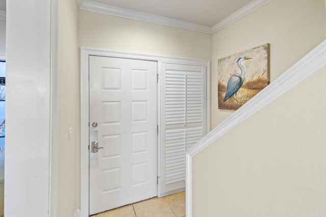 entrance foyer featuring light tile patterned floors and ornamental molding