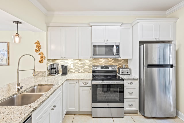 kitchen featuring ornamental molding, a sink, appliances with stainless steel finishes, white cabinets, and decorative backsplash