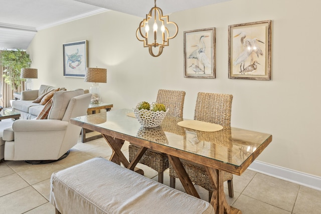 dining space featuring a notable chandelier, light tile patterned floors, baseboards, and ornamental molding