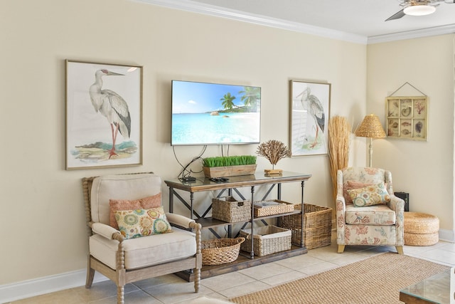 living area with baseboards, a ceiling fan, crown molding, and tile patterned flooring