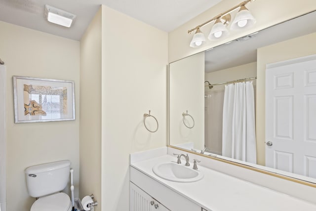 bathroom with visible vents, toilet, vanity, and a shower with shower curtain