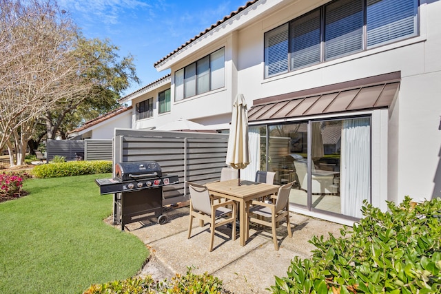 view of patio featuring outdoor dining area and a grill