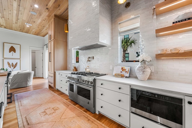 kitchen featuring range with two ovens, light wood-type flooring, wood ceiling, and tasteful backsplash