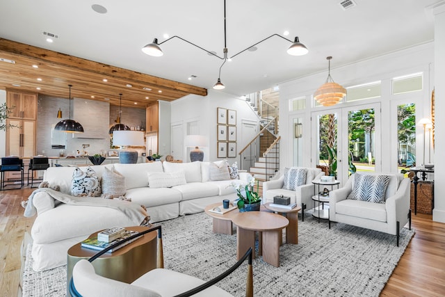 living room with stairway, wood finished floors, visible vents, and recessed lighting