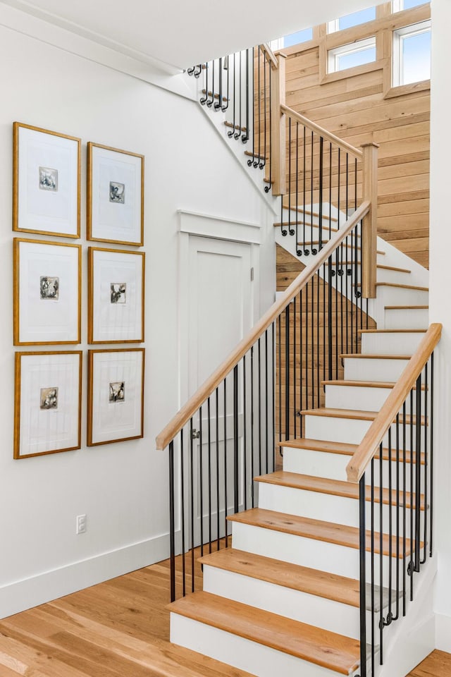 stairway with baseboards and wood finished floors