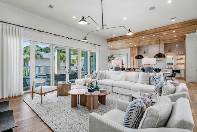 living room with recessed lighting, visible vents, and light wood-style floors