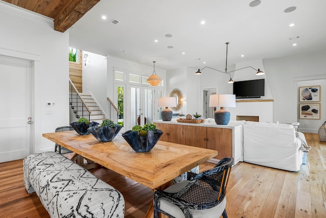 dining room with light wood-type flooring, stairway, visible vents, and recessed lighting