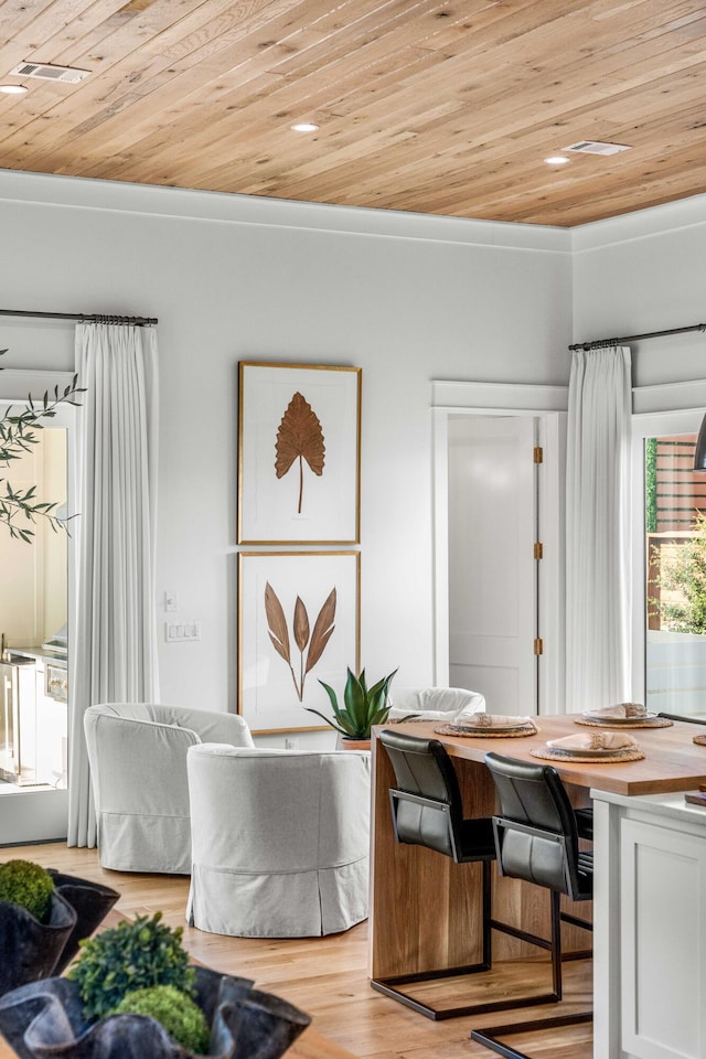 dining space with wooden ceiling and light wood-style flooring