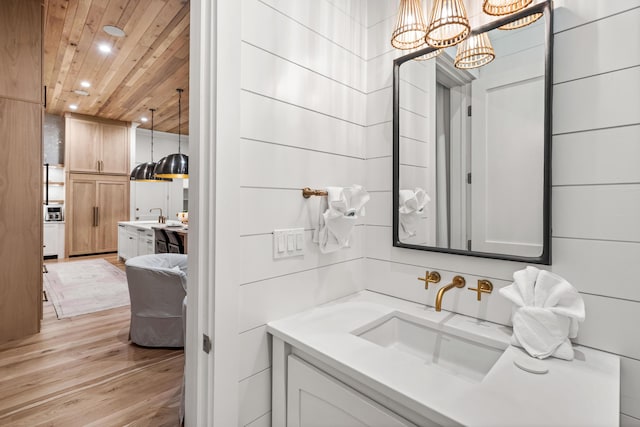 bathroom with recessed lighting, an inviting chandelier, wood ceiling, vanity, and wood finished floors