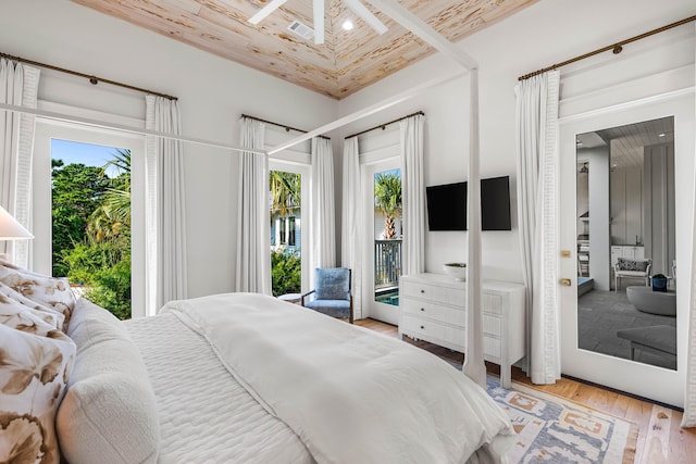 bedroom featuring access to outside and wood finished floors