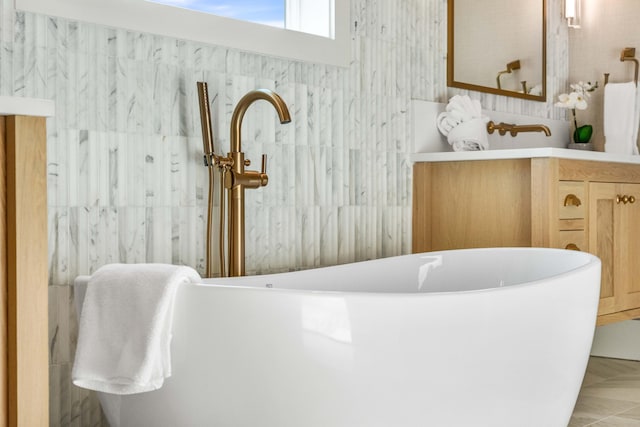 bathroom featuring a freestanding bath and vanity