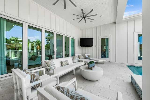 view of patio with ceiling fan and an outdoor living space