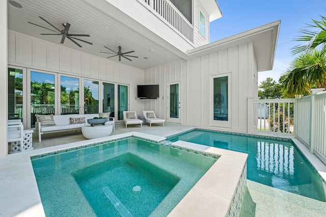 view of swimming pool featuring a pool with connected hot tub, an outdoor hangout area, a ceiling fan, and a patio