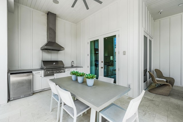 view of patio featuring ceiling fan, outdoor dining area, area for grilling, a sink, and a grill