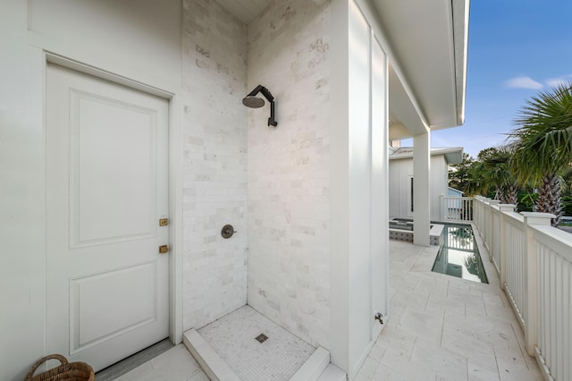 bathroom with tiled shower