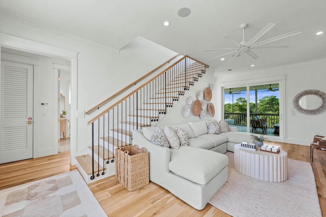 living area with ceiling fan, stairway, wood finished floors, and recessed lighting