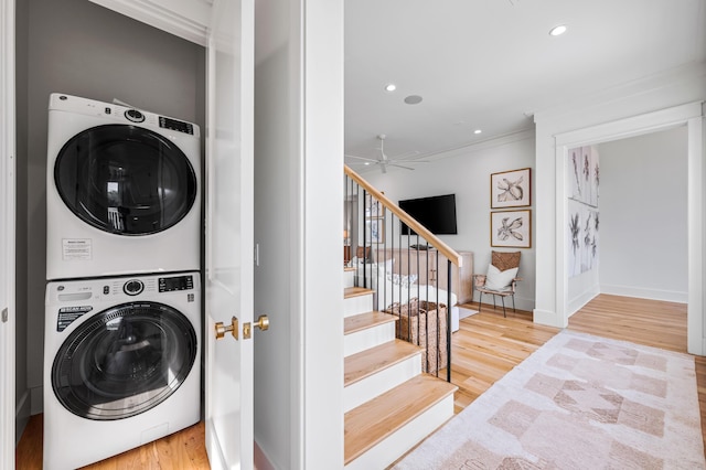 laundry room with stacked washing maching and dryer, laundry area, wood finished floors, and recessed lighting